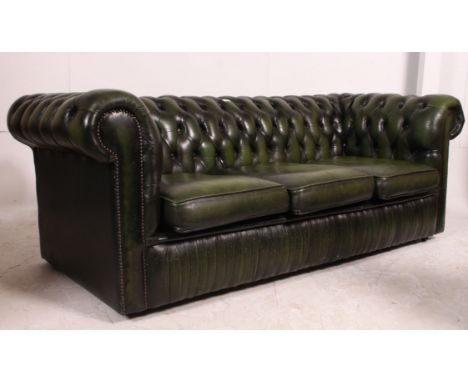 A green leather three seater Chesterfield sofa. The sofa with with buttoned back green leather and three seat cushions. Match