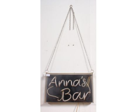 A retro neon light advertising sign for ' Anna's Bar ' in working order within a perspex box. Measures: 28cm x 46cm x 9cm.
