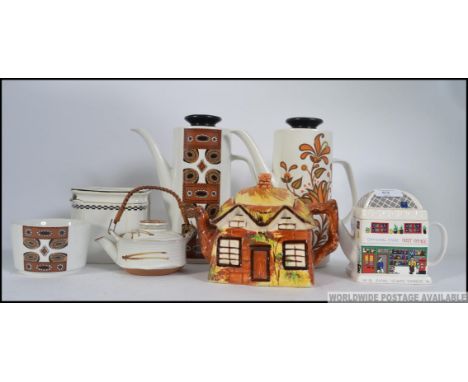 A collection of ceramic Teapots and coffee pots to include retro Meakin, The cube teapot by Foley and others please see image