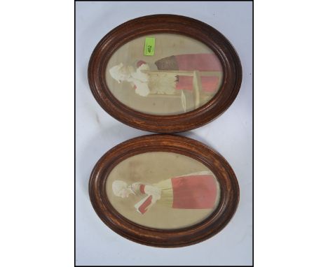 A pair of early 20th century dutch photograph portrait studies being handpainted set within good oval oak frames.