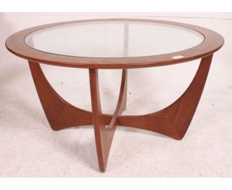 A vintage teak 1970's atomic style oak quarter veneer round coffee table with glass insert top and lower shelf. Measures: 45c