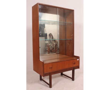A vintage mid century teak mirror back display bookcase stand having breakfront centre base drawer with mirror inset cabinet 