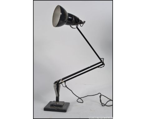 A 1940's Industrial pre-war Herbert Terry anglepoise lamp, raised on a cast metal two step base with pendant shade, finished 