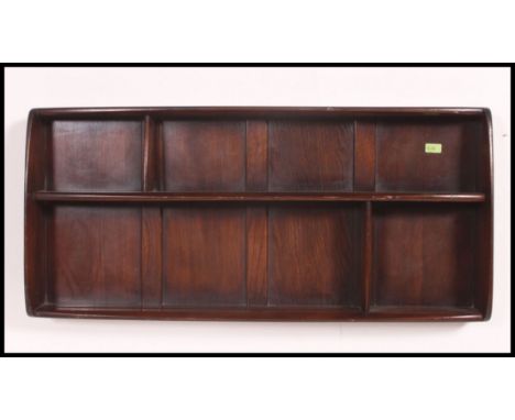 A 1970's Ercol plate rack having shelved centre with panel back in beech and elm ( see illustrations ) H50xW108xD12cm
