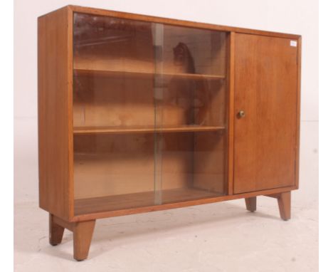 A vintage ' utility / cc41 ' type display / bookcase stand with glass sliding doors to the left with adjustable shelves and c