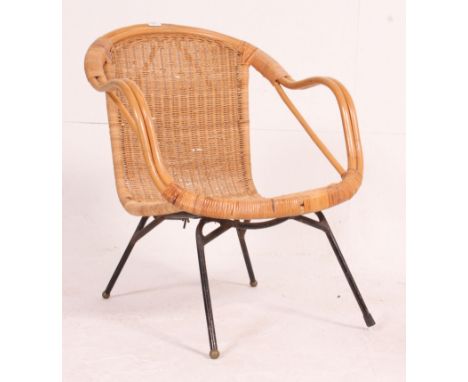 A vintage 1960's rattan weave bedroom chair having shaped rattan weave seat over tubular metal sputnik style base. Measures: 