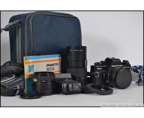 A cased Praktica BCA electronic 35 mm camera with accessories to include light meter, flash head and lenses