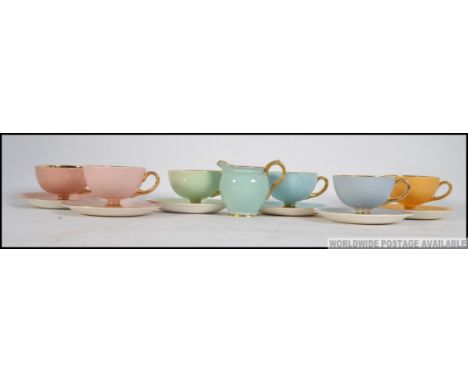 A set of 6 Norsk Egersund colourful cups and saucers from the mid 20th century together with a similar creamer by Crown Staff