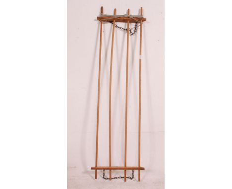 A vintage early 20th century pine rise and fall clothes airer pole system. Measures: 185cm x 54cm.