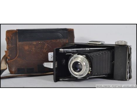 A vintage 20th century Agfa folding camera fitted with a Vario lens Cased . Measures: 18cm W.