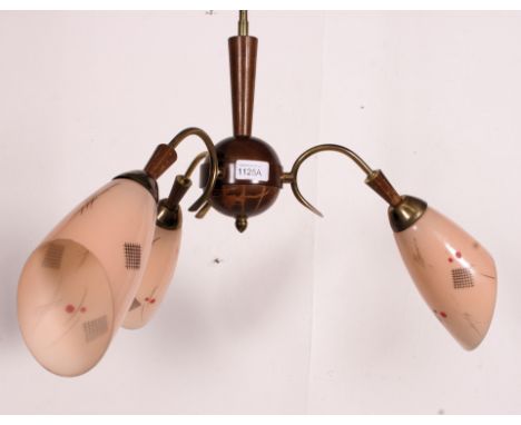 A vintage 1950's 3 branch oak and glass cylindrical ceiling light fitting chandelier. The shades of glass form in peach colou