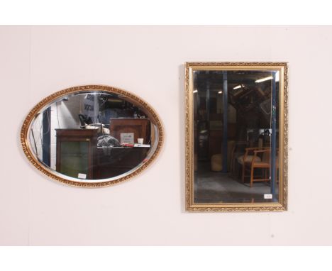 A 20th century gilt framed rectangular mirror together with a near matching oval gilt mirror. Both with bevelled plate mirror