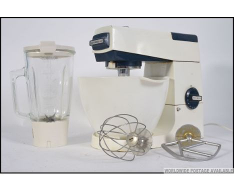 A vintage / retro Kenwood food mixer, complete with mixing bowl, K beater, whisk and blender attachment. Measures: 30cm H.
