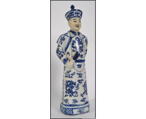 A 20th century ceramic figure of a Chinese scholar, in blue and white with character marks to base. Measures: 46cm H.