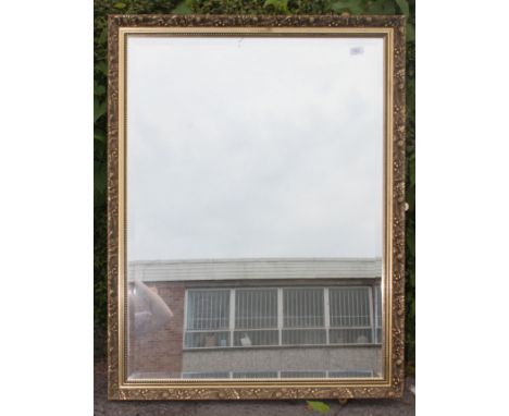 A 20th century large antique  bevelled edge gilt mirror of rectangular form having original back panels in place. Measures: 1