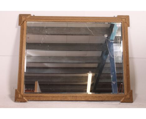 A 19th century large  moulded gilt framed wall mirror. The gilt wood frame with decorative design having squared corners. Mea
