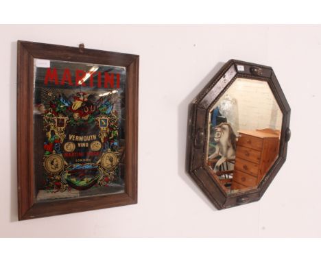 A 1920's Octagonal Jacobean revival oak wall mirror with bevelled plate mirror glass together with an advertising shop / pub 