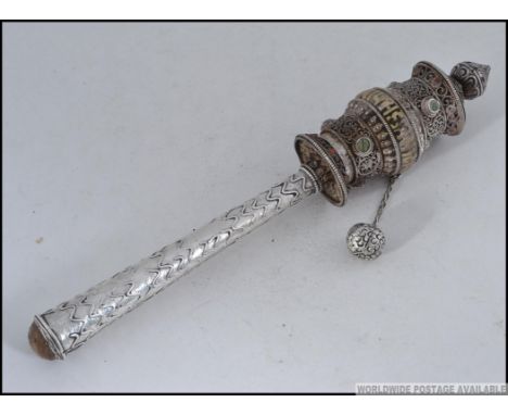 AN INTERESTING TIBETAN PRAYER RATTLE IN SILVER METAL, FILIGREE WORK WITH PAPER SCROLL INSIDE
A Chinese / Tibetan temple paper