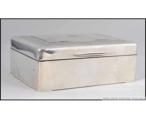 An Edwardian Sampson Mordan & Co silver hallmarked table top cigarette case with engine turned lid, central monogram being bo