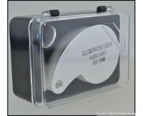 A new and unused cased Jewellers loupe having metal surround and good magnification.