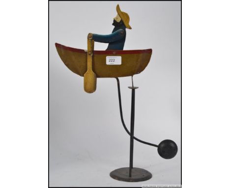 A vintage 20th century wooden hand painted sailor and rowing boat balance figure  pendulum. Measures: 40cm H