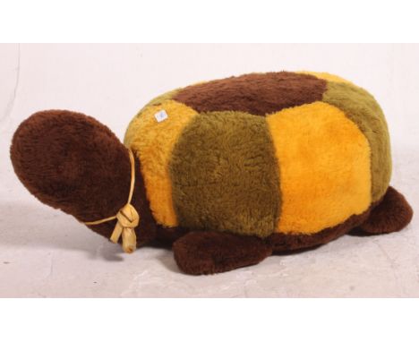 A kitsch retro 20th century large tortoise foot stool or pouffe seat in faux fur plush fabric being heavily stuffed and with 