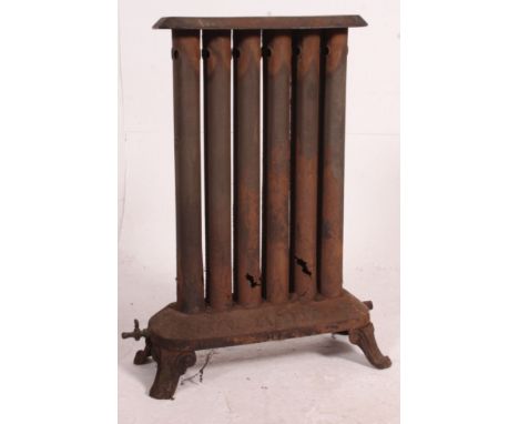 An early 20th century large cast iron architectural radiator with plinth base, six cylinder uprights and platform top. Measur