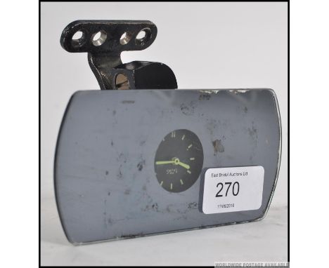 A vintage 20th century Smiths M.A. rear view mirror with inset clock. The clock with luminous baton numerals and hands, brack