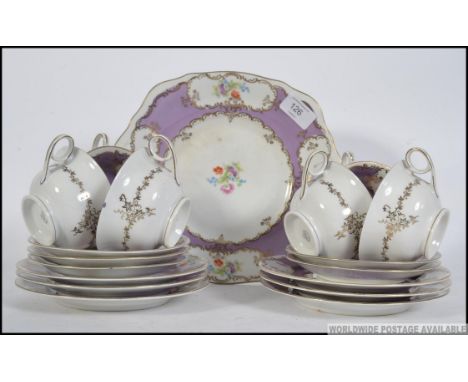 A 20th century vintage chintz china tea service, having a violet ground with transfer printed flowers to include plates, cups
