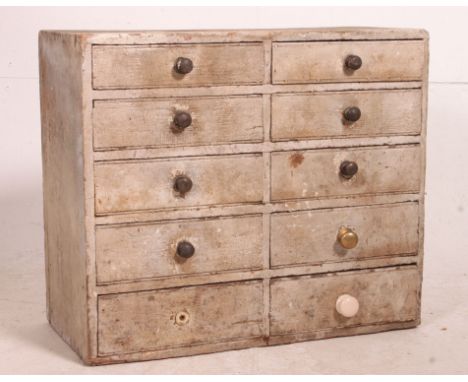 A vintage mid century Industrial 10 drawer filing cabinet with knob handles, the wooden cabinet with remains of original pain