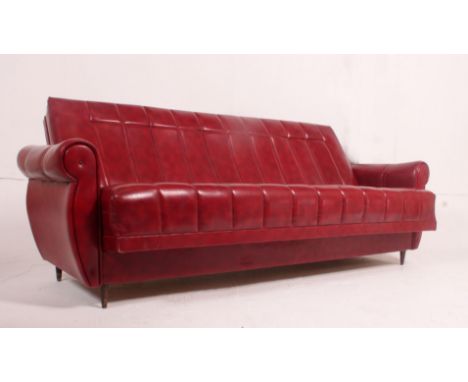 A fabulous retro 1950's red vinyl sofa settee day bed raised on tapering suports. the upholstered body with squared arms. Mea