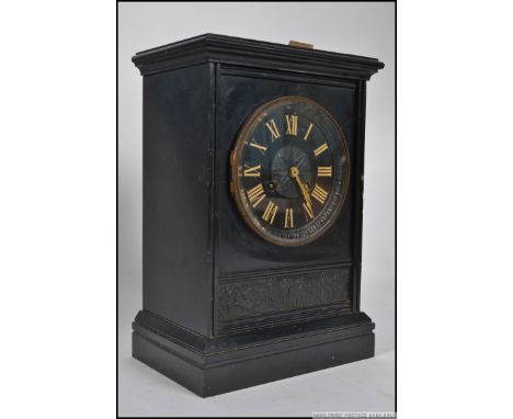 A late 19th/early 20th century black slate eight day mantle clock, enamel dial with Roman numerals. Measures: 33cm x 23cm x 1