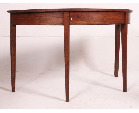 A 19th century oak demi lune console table raised on squared legs with half moon table top above. Measures: 73cm x 120cm x 60