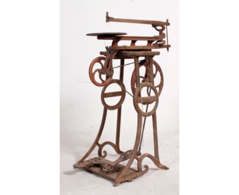 A vintage early 20th cenutry Seneca Falls Mfc Co cast iron woodworking treadle machine. Measures: 90cm x 32cm x 63cm.