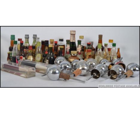 A collection of vintage miniatures along with vintage mid century chrome drink pourers etc