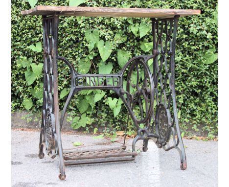 A vintage garden table being constructed from an upcycled Singer sewing machine treadle base with later top. Measures: 73cm x
