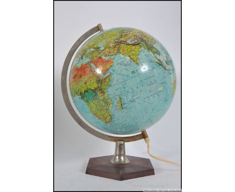 A retro 1976 A retro 1970's Danish made Scan Globe terrestrial illuminated globe, supported by a chrome jibb on a bakelite st