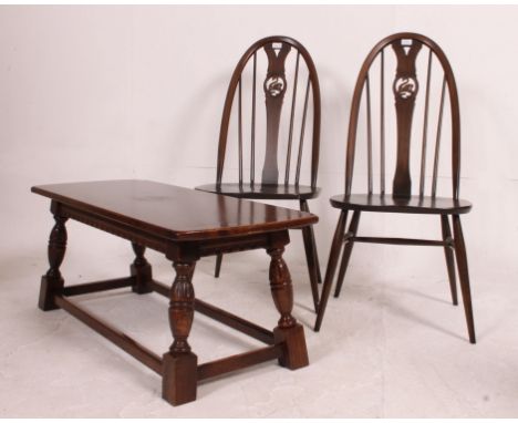 2 Ercol beech and elm quaker style dining chairs together with an oak refectory style coffee table. Measures: chair 100cm H.