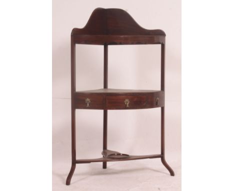 A 19th century Georgian mahogany corner washstand having three tiers, the upper gallery surround tier with bowl recess having