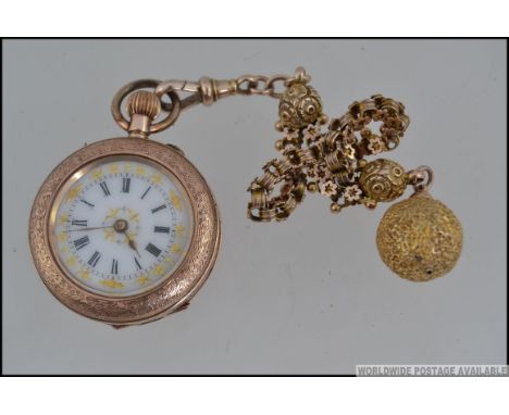 A 9ct gold ladies fob watch with decorative face being set on a stunning 9ct chain and ball finial. Total weight 29.6g