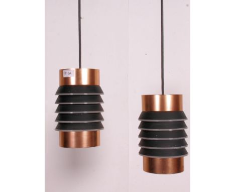 A pair of 1970's retro copper cylindrical drop pendant light shades having squeeze box style centres. Measures: 22cm x 12cm d