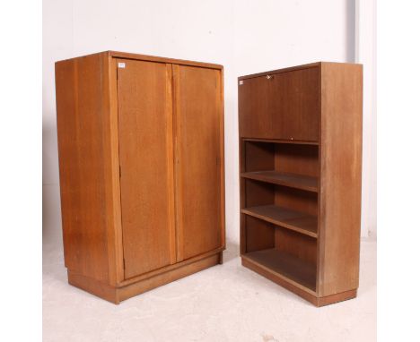 A vintage golden oak tallboy having cupboards and drawers together with a mid century students bureau with fall front bureau 