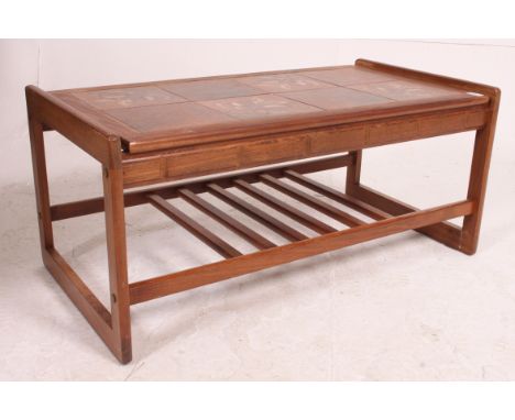 A 1970's Danish influence teak and tile top coffee - occasional table raised on suspension set legs with tiled centre. Measur