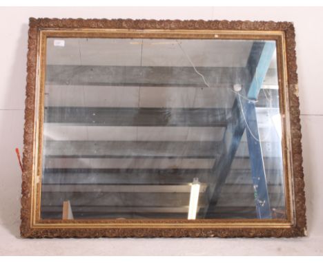 A 19th century ornate plaster gilt framed wall hanging mirror having a later central mirror panel. Measures: 102cm x 82cm.