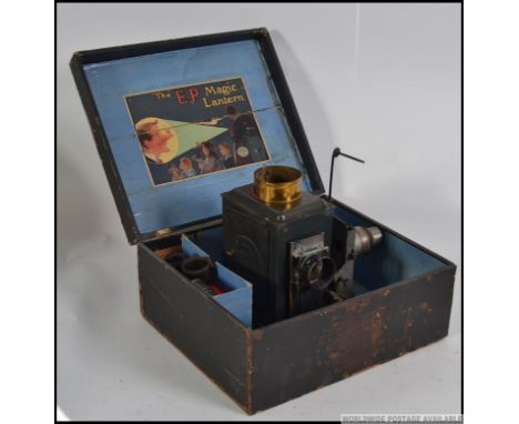 An early 20th century possibly Bing or Marklin made childs Magic Lantern projector kit. Comes with an assortment of original 