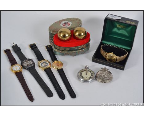 A collection of Gents wrist watches and pocket watches to include Rotary, Ingersol etc along with a pair of cased musical bal