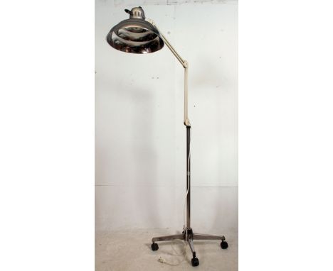 A vintage retro machinist / dentist floor standing Industrial anglepoise lamp having a polished pendant shade raised on a lat