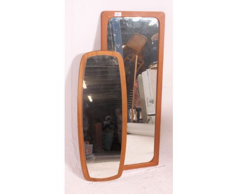 2 vintage 20th century atomic style teak wood wall mirrors. Each with teak back panels to the frameless mirrors. Measures: 96