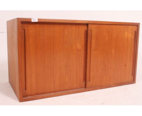 A Danish teak modular wall hanging piece in a retro vintage style.  Sliding fronts doors which conceal adjustable shelving.  