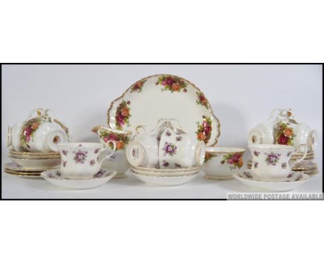 A collection of Royal Albert Country Roses bone China tea service, consisting of trios, creamer, sugar bowl, bread plate, alo